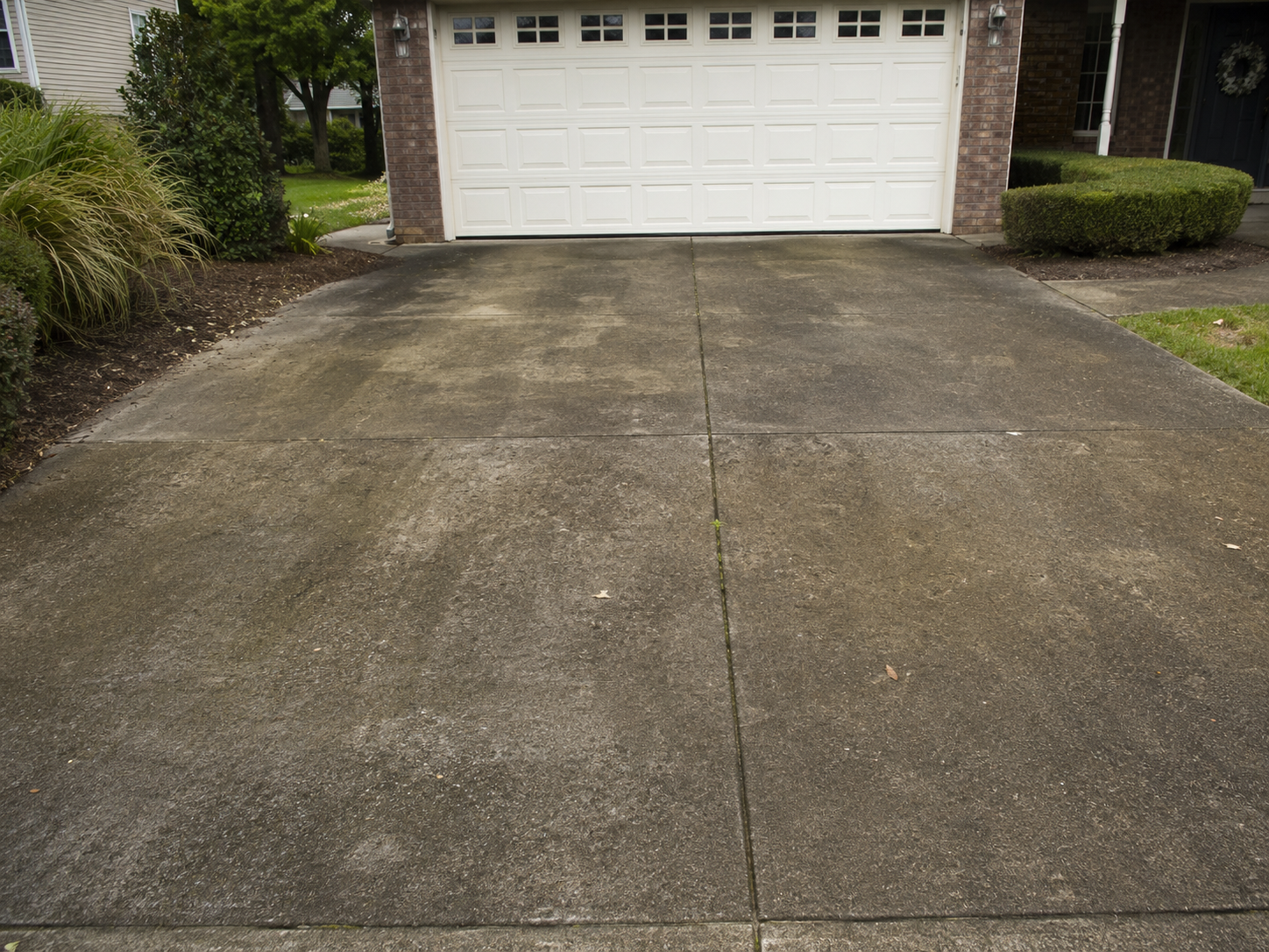 Driveway before pressure washing